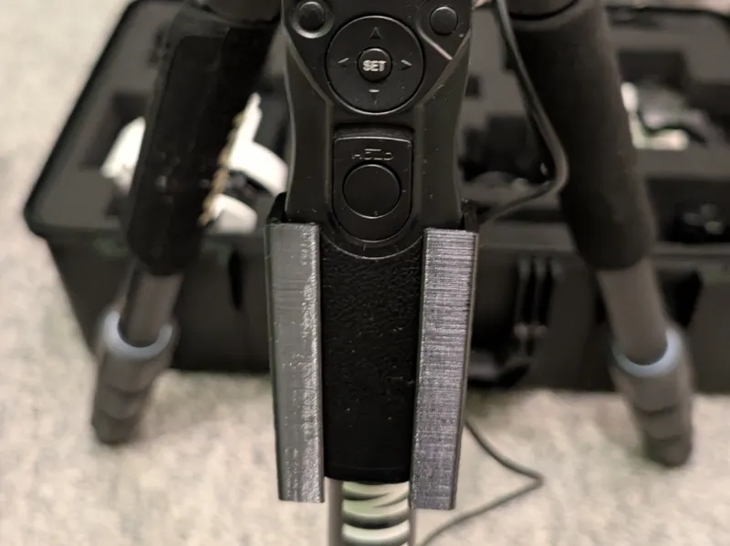 Time-lapse intervalometer holder for tripod