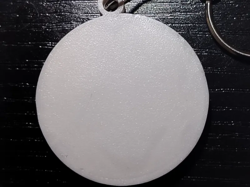 Flat round pocket whistle keychain