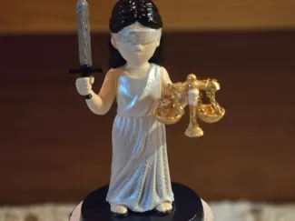 Lady Justice with Scales Standing on a Coliseum