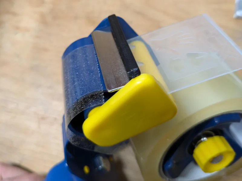 Protective cover for adhesive tape dispenser