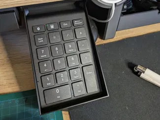 Tiltable desk drawer
