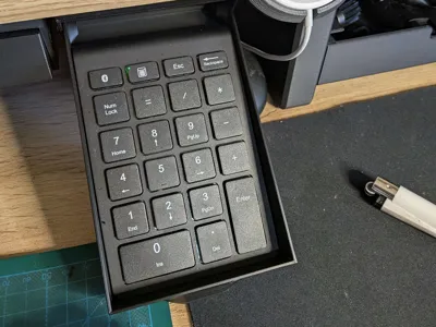 Tiltable desk drawer