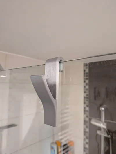 Towel holder for the shower glass panel