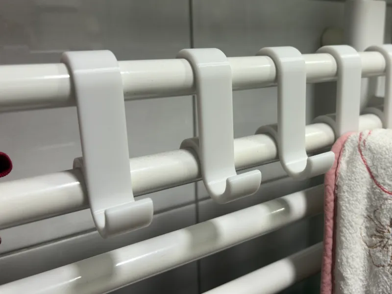 Towel hook for a bathroom radiator