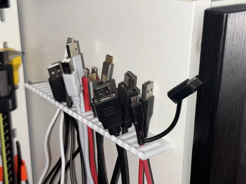 Wall / furniture mounted cable holder; 200mm wide