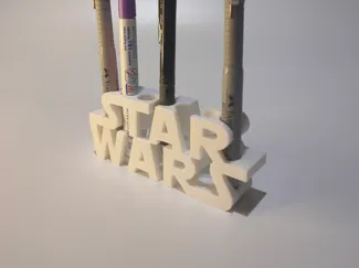 Pencil holder with superhero logos.