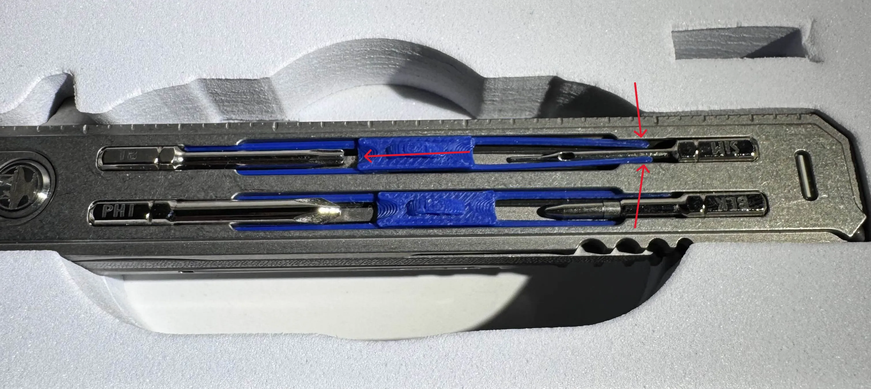 Slide the Bit Lock all the way into the first side. Then push the side that is still sticking out into the gaps on the sides of the other bit.