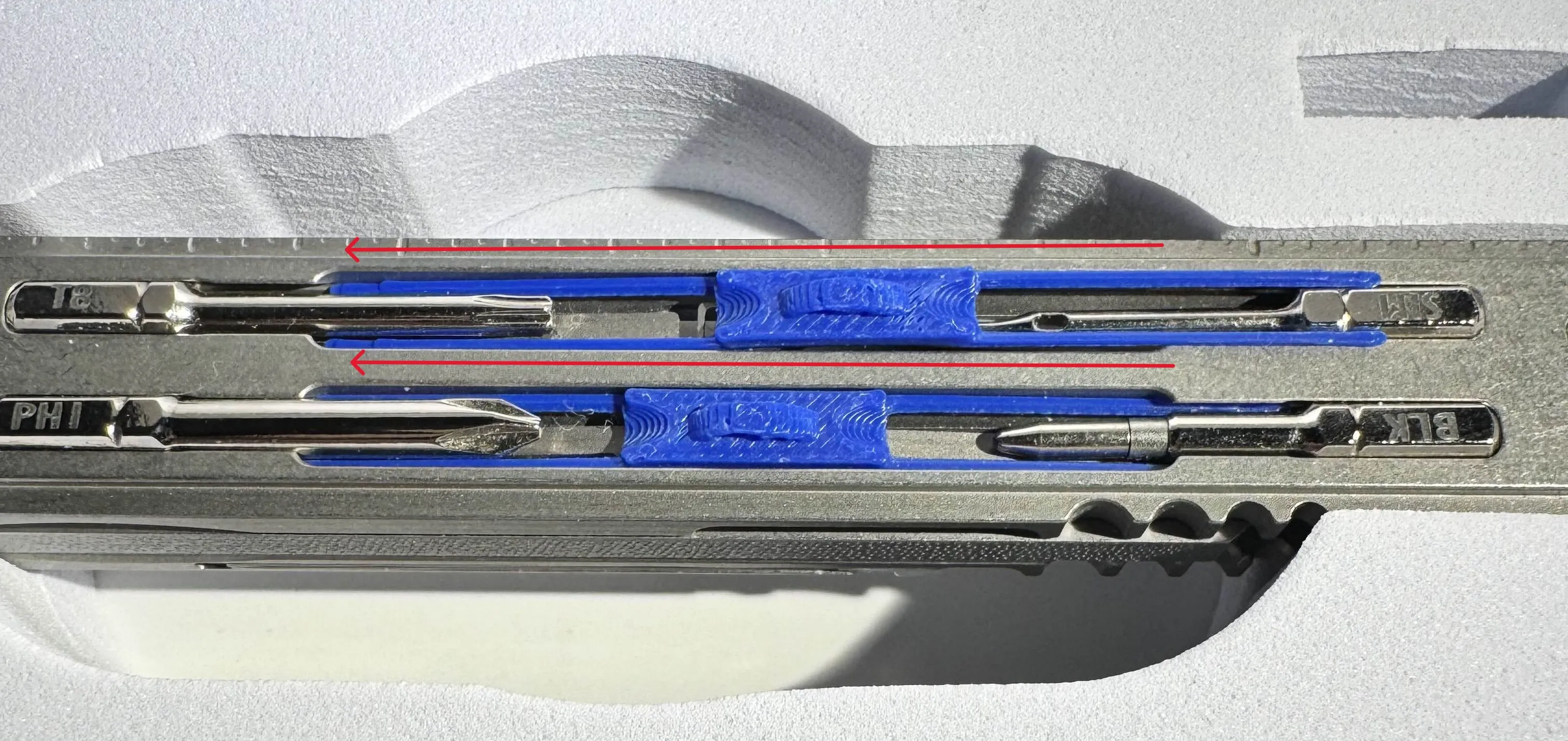 Slide one end of the Bit Lock to the sides of one bit.