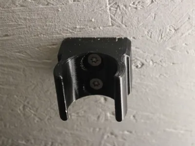 Wall mount for a vacuum cleaner nozzle