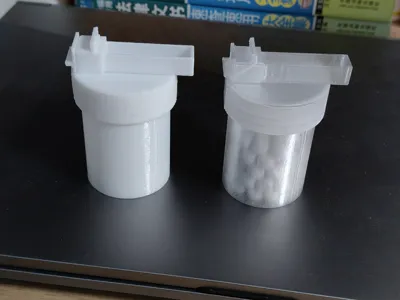 A bottle dispenses a round ball with one press