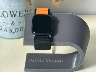 Apple Watch charging stand with inscription.