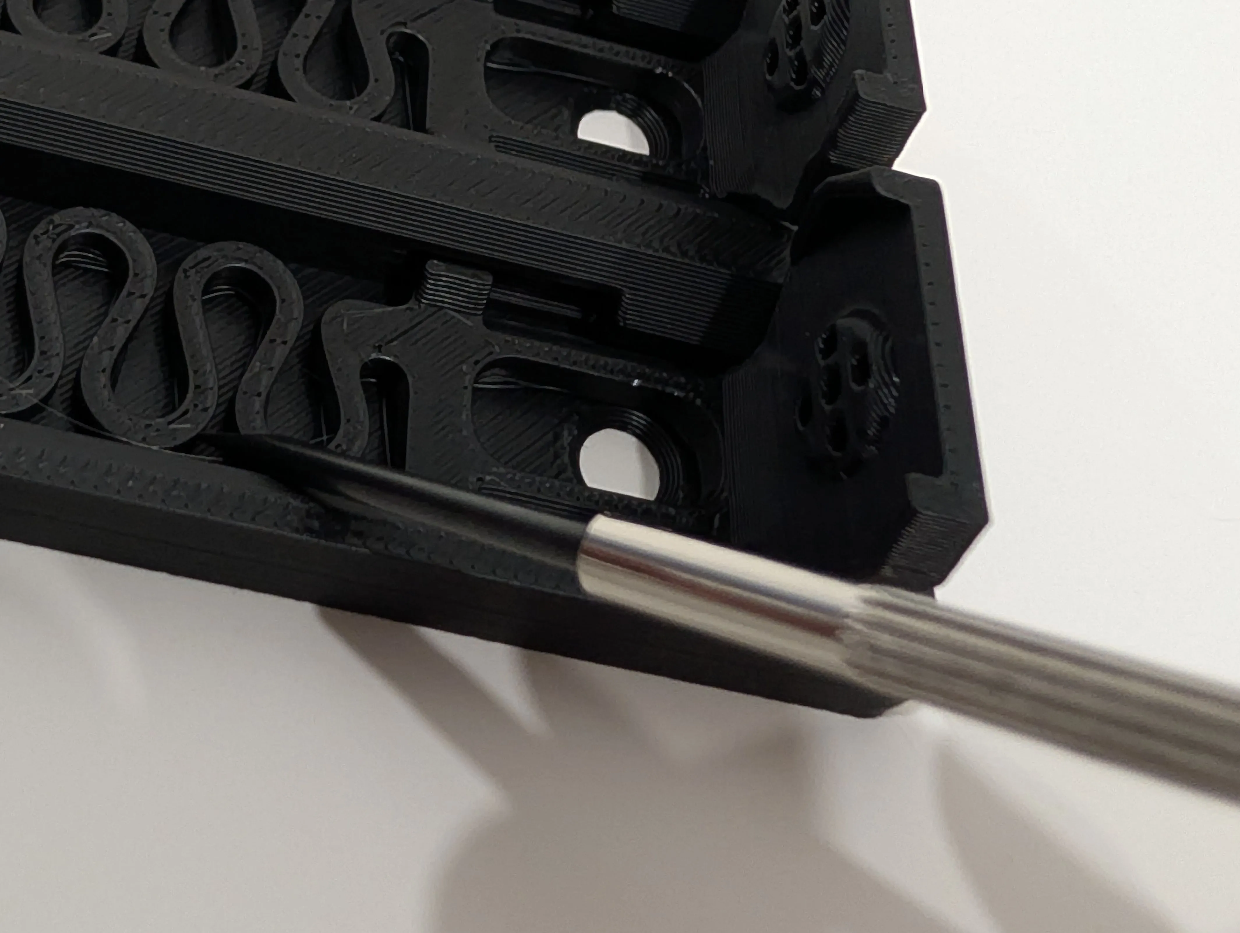 Photo showing the user snapping the spring with a mini screwdriver
