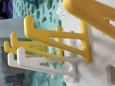 IKEA pegboard hook 50mm long, reinforced to prevent 15-inch laptops and iPads from falling