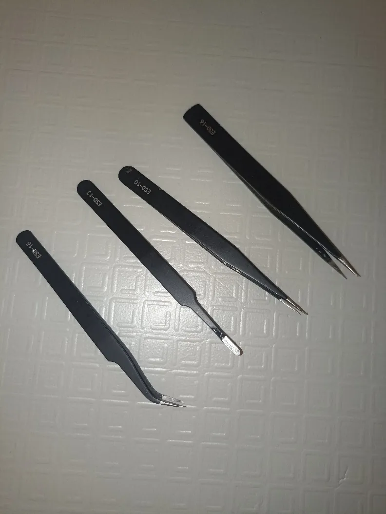 A group of black tweezers
Description automatically generated