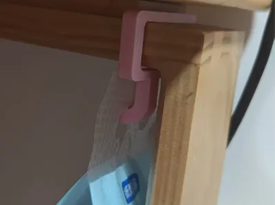 Under-desk hook for a large cola bottle