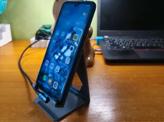 Phone stand for side charging cable