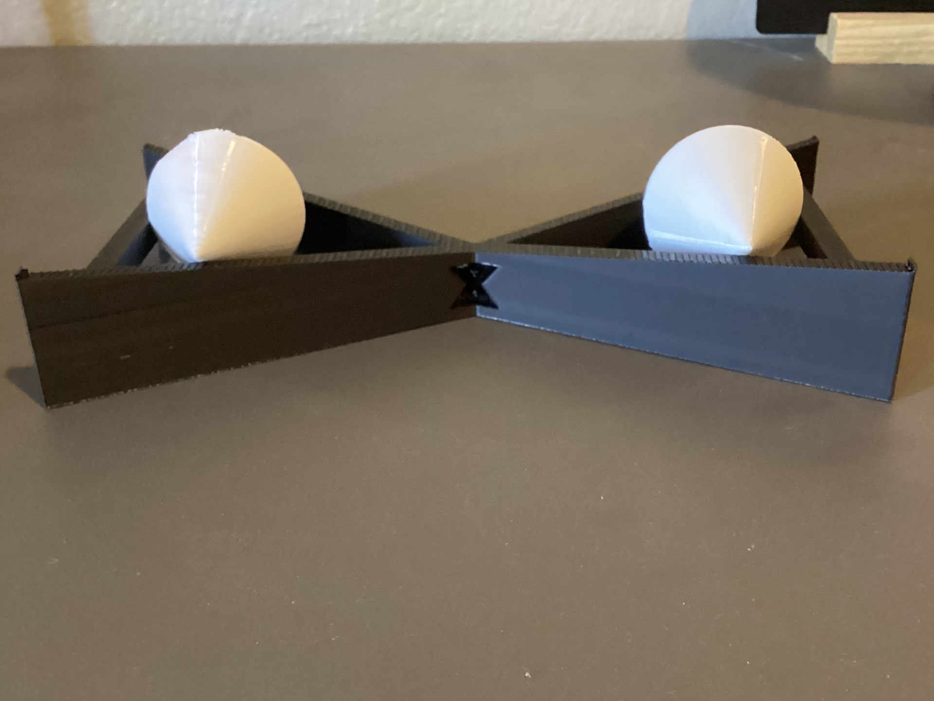 Gravity Defying Rolling Upwards Double-Ramp