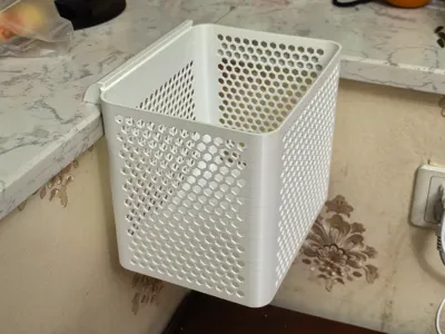 Desk-side trash can A trash can that can be attached to the side of a desk or windowsill, recommended to print with PETG