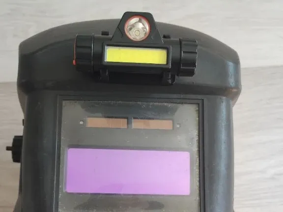 Attaching the flashlight to the welding mask