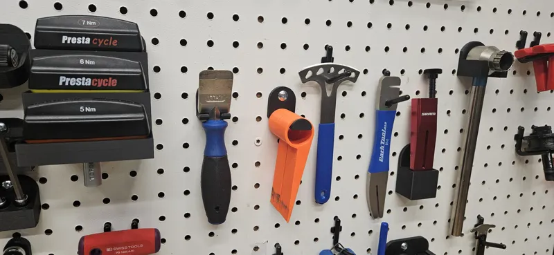 Pegboard holder for CMH caliper piston spreaders
