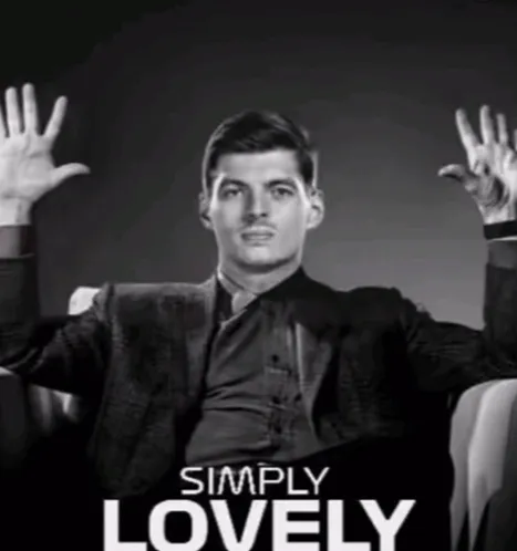 a man in a suit is sitting in a chair with his hands in the air and the words simply lovely above him