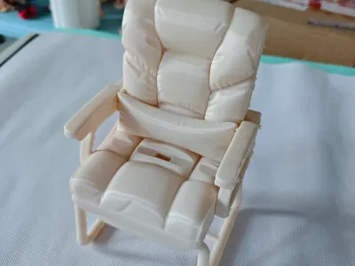 Sofa and chair shaped phone stand, with charging cable access