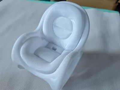 Sofa-shaped phone stand with charging cable slot