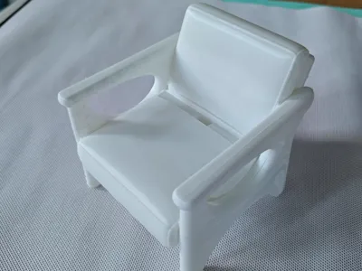 Sofa chair style phone holder with charging cable access