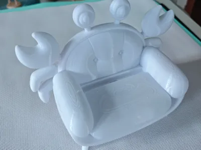 Crab-shaped phone stand for sofa and chair with a charging cable slot