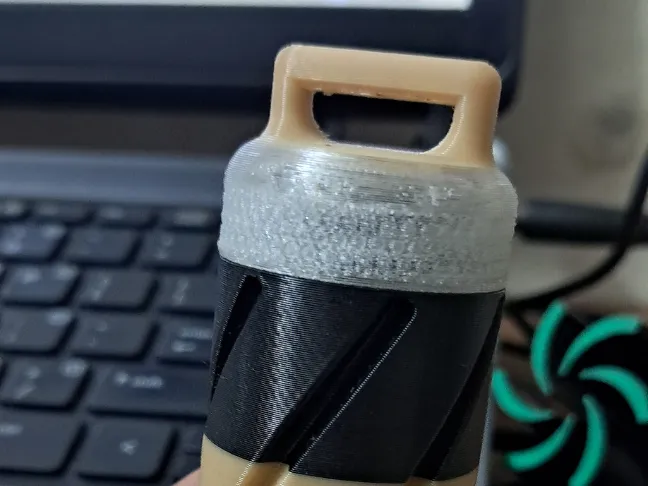 “container that can be attached to a keychain.”