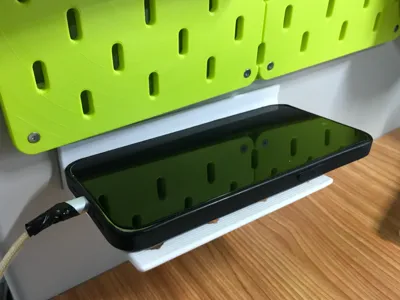 Wall-mounted angled phone charging holder