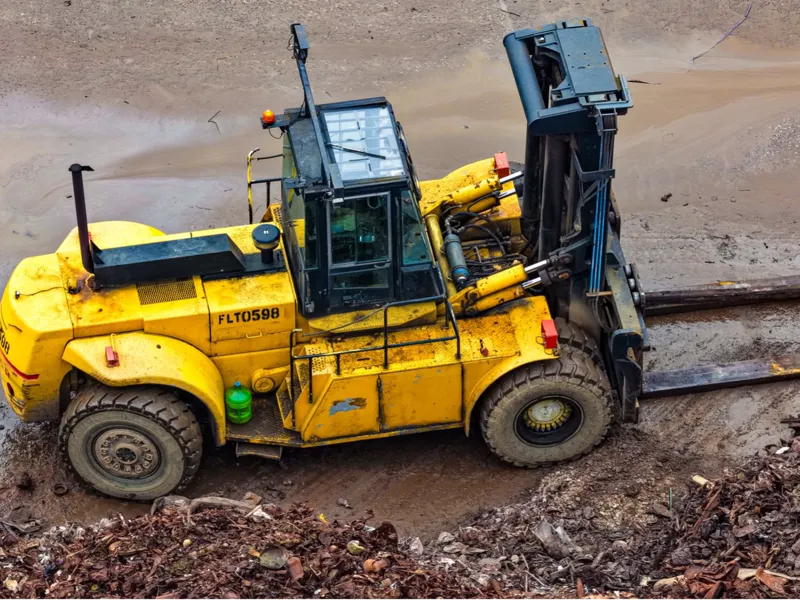 Yellow forklift at scrapyard