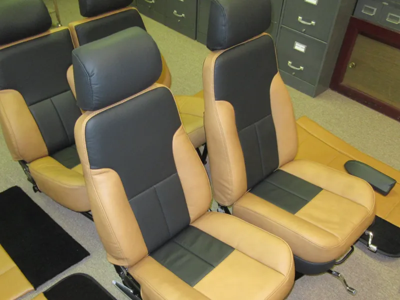 Tan and black leather captain chairs in an office