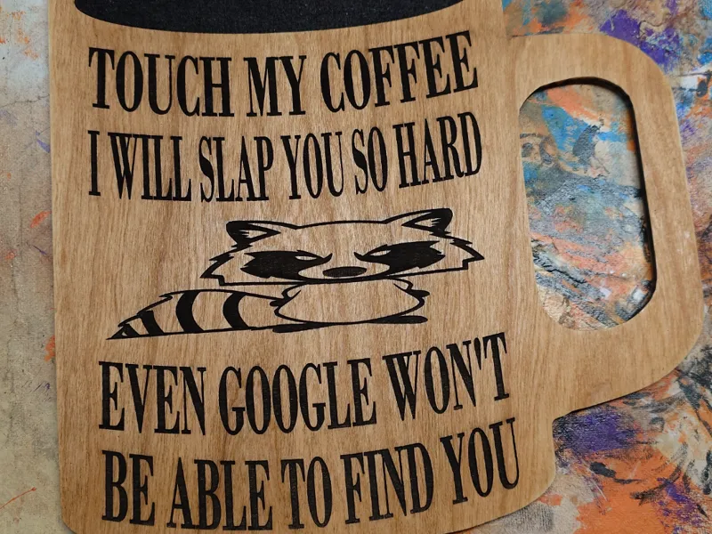 Don't touch a grumpy raccoon's giant coffee mug!
