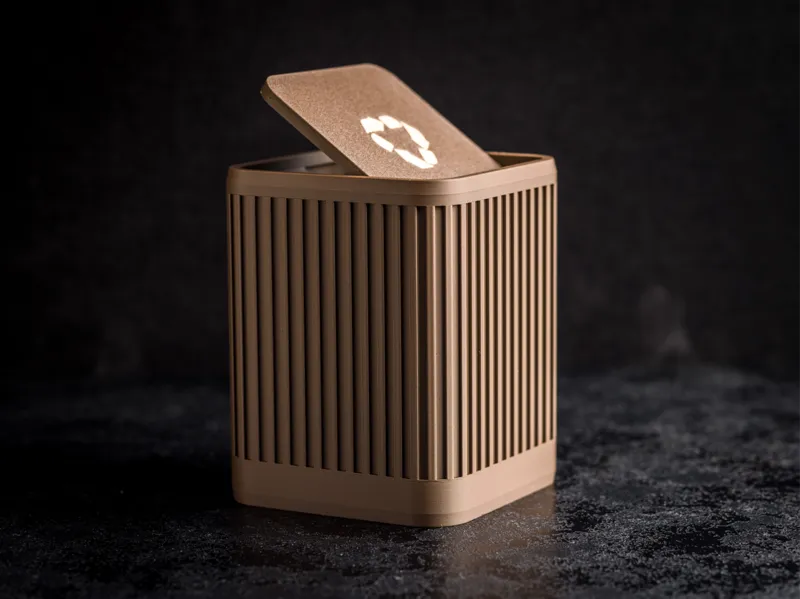 Ribbed trash bin with recycle sign on lid lid.