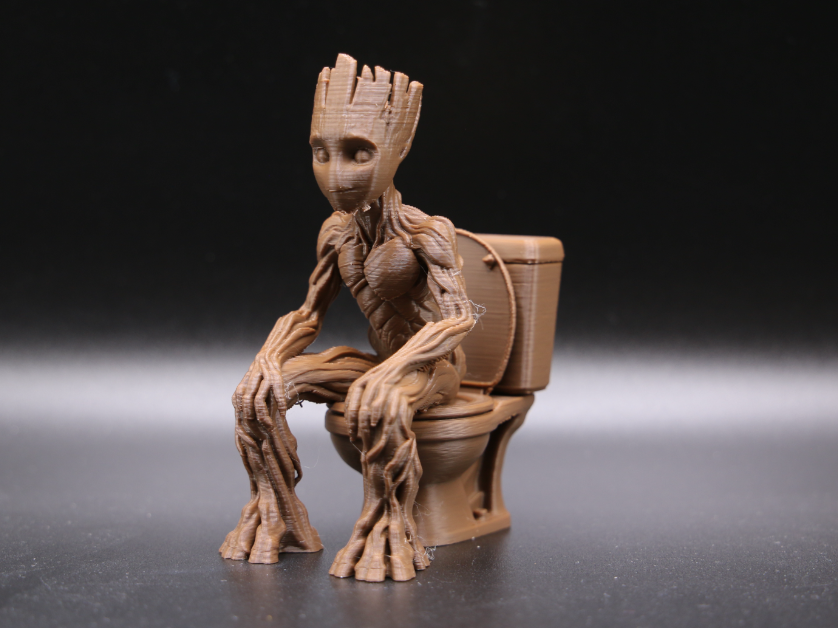 Groot sitting on a toilet - sad or even happy