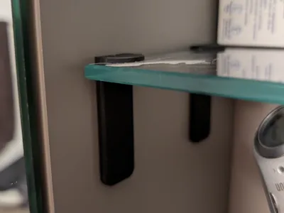 Raising glass shelves in bathroom furniture