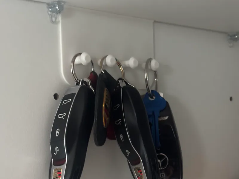 Car key hanger under kitchen shelf