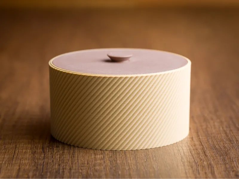 Round box container with lid.