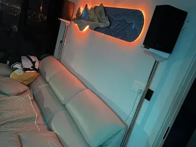 Floor-standing speaker stand against wall for sofa