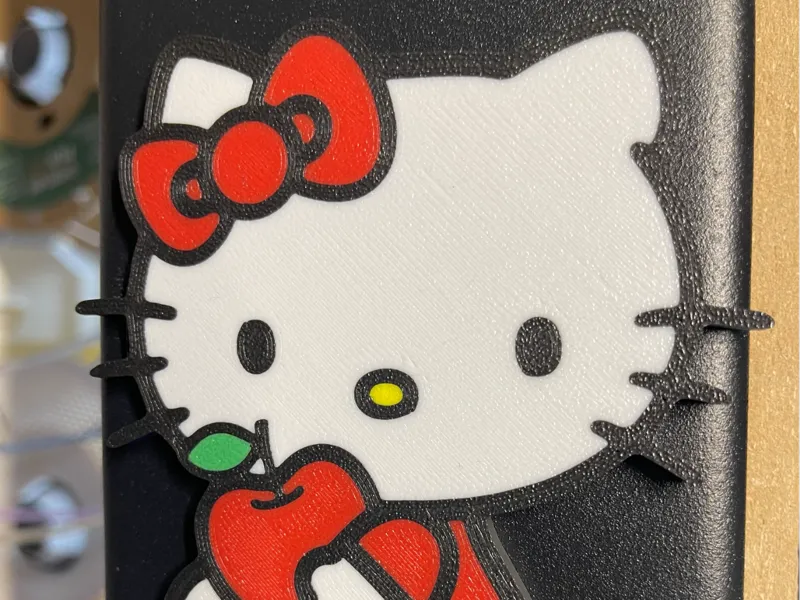 Hello kitty holding apple
