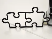 Two puzzle pieces 0.2mm layer, 2 walls, 15% infill