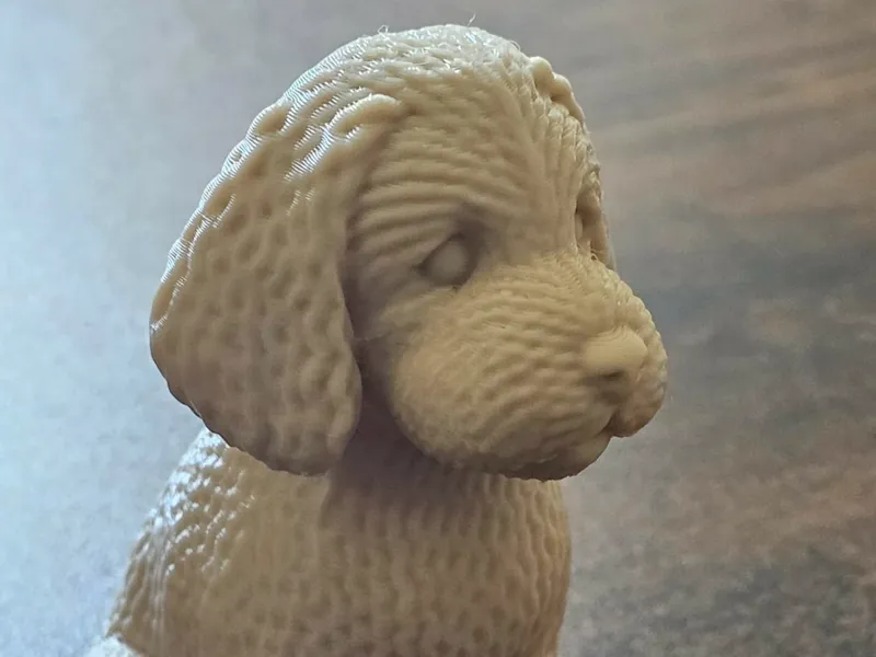 Knitted labradoodle sitting down