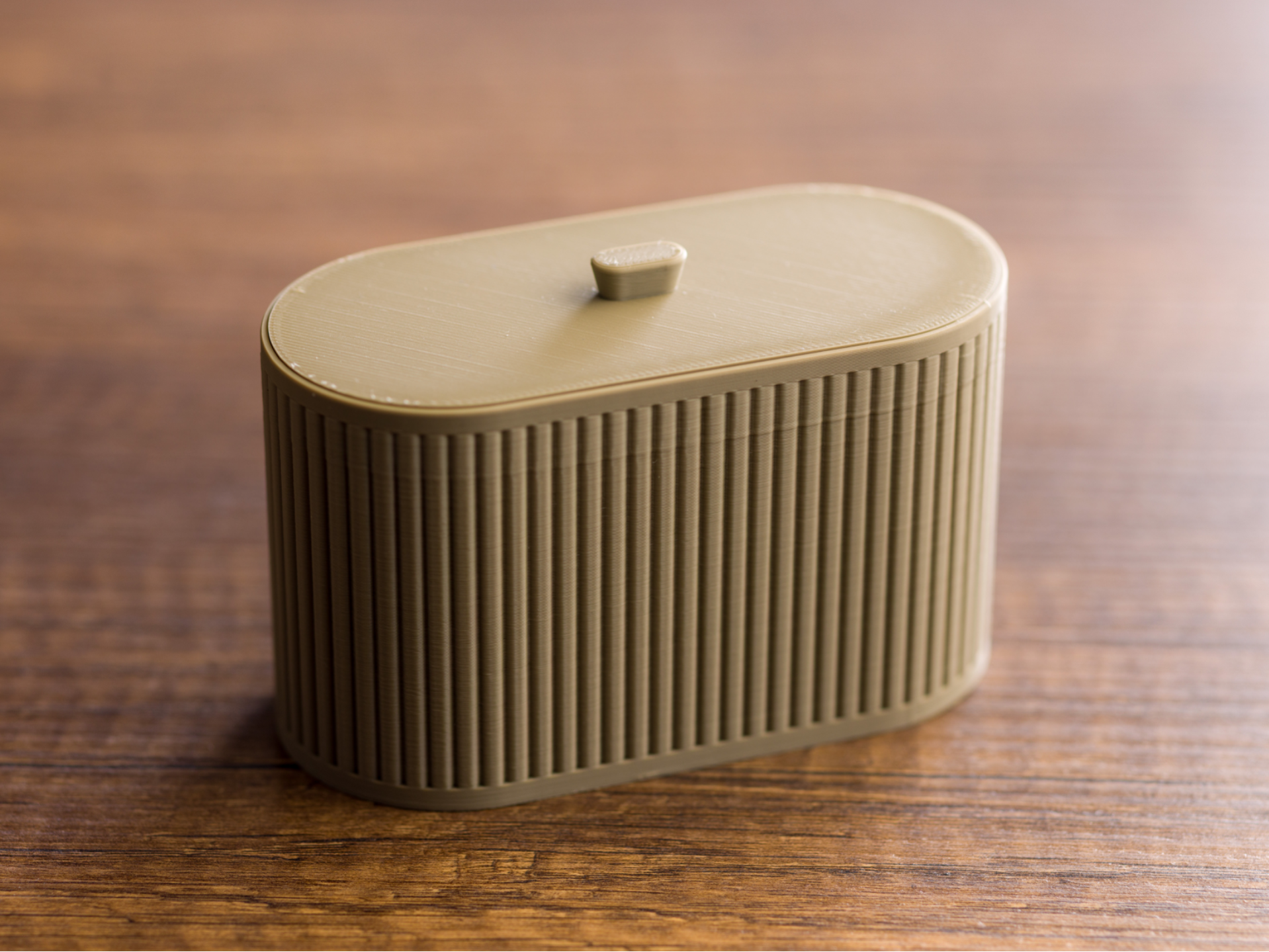 Oval ribbed box with lid.