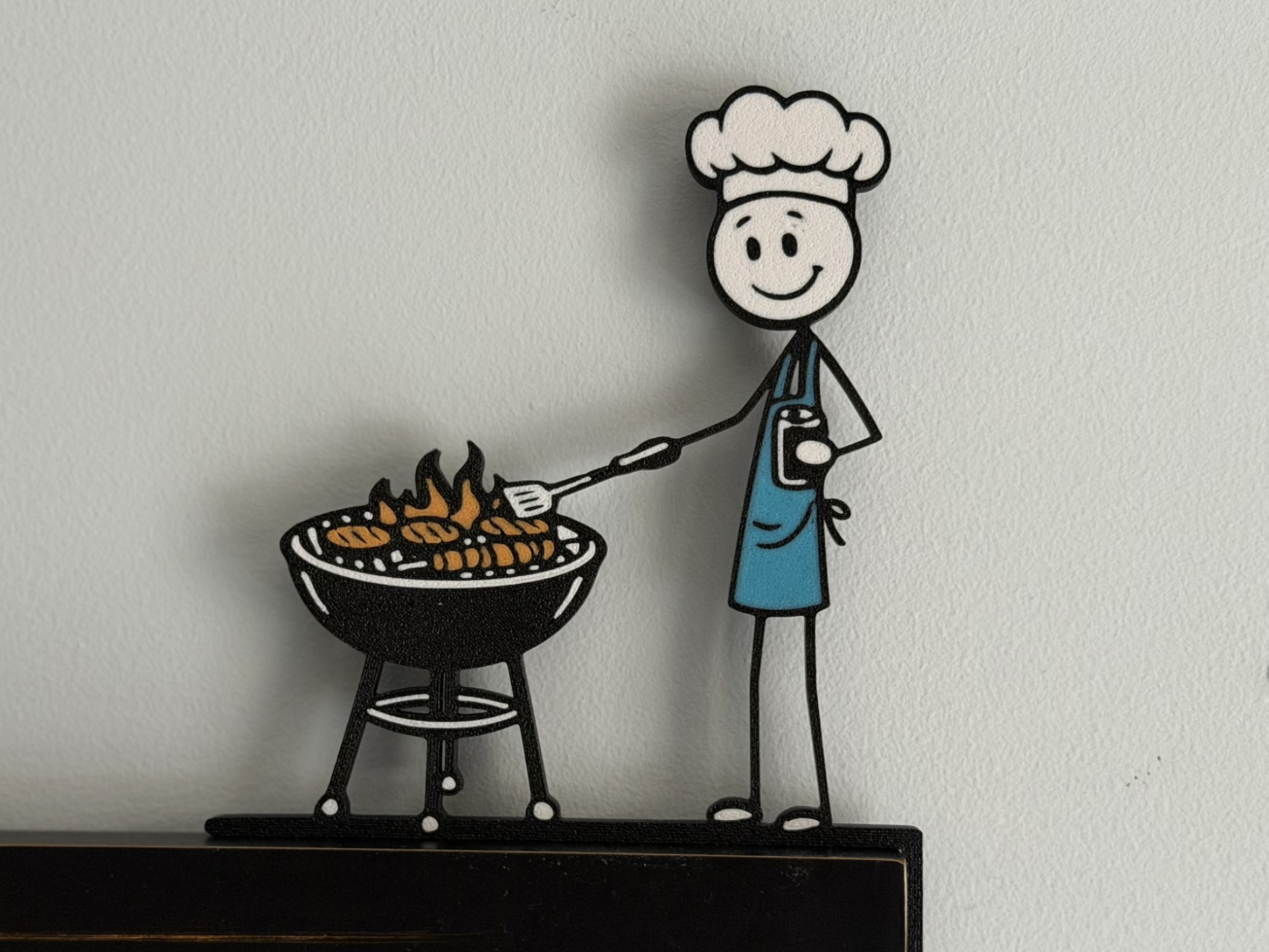 Stick Man cooking on the grill - door corner decor