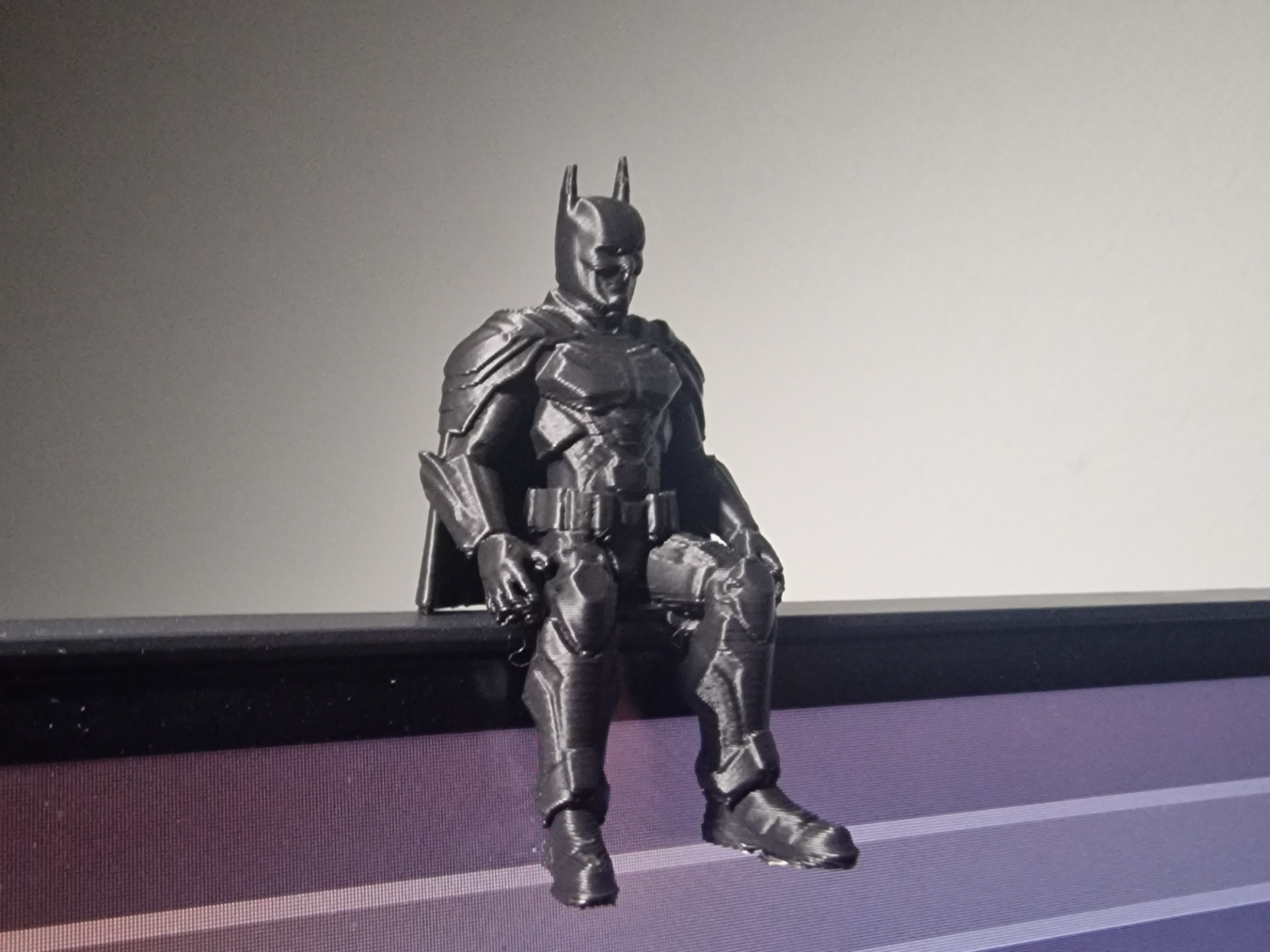 Batman Figure Sitting on a ledge