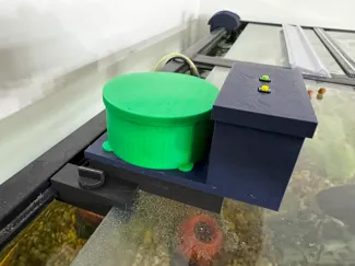 Remote controlled fish pellet feeder