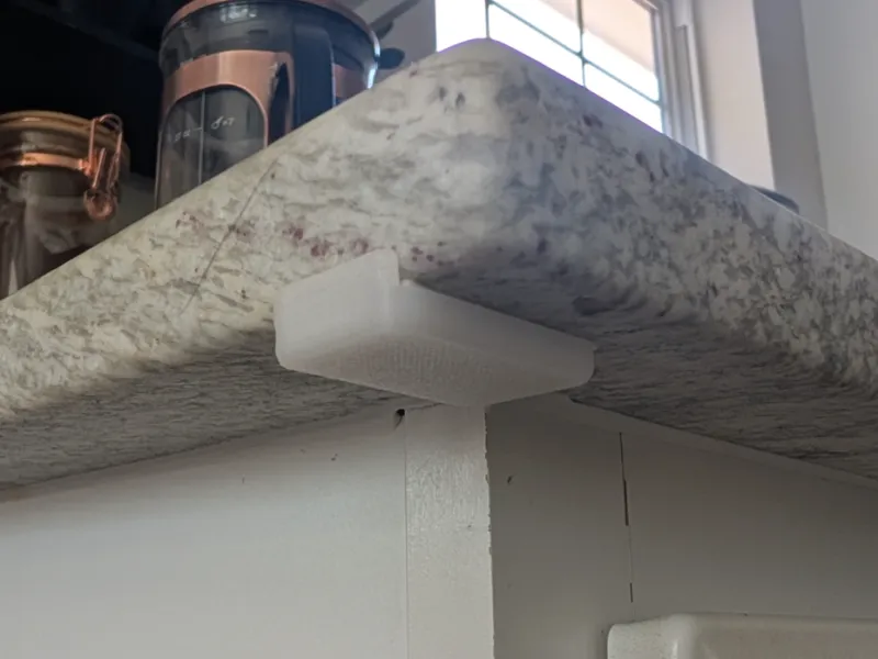 Under-counter bumper - prevent trashcan lid dents