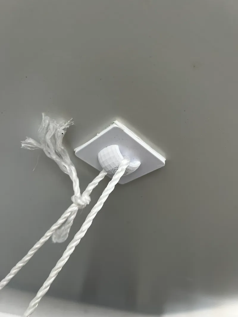 Strong ceiling loop for hanging decorations from smooth surfaces using sticky tabs