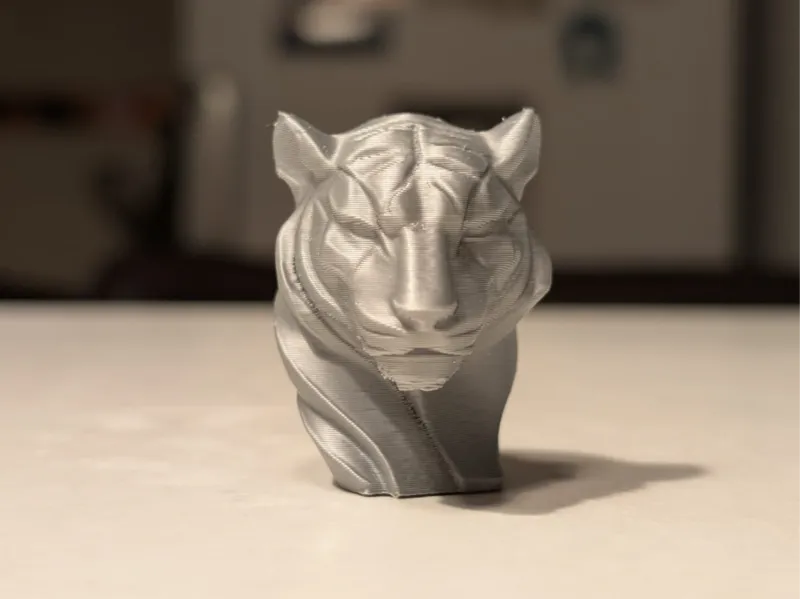 Two versions of Tiger head statues
